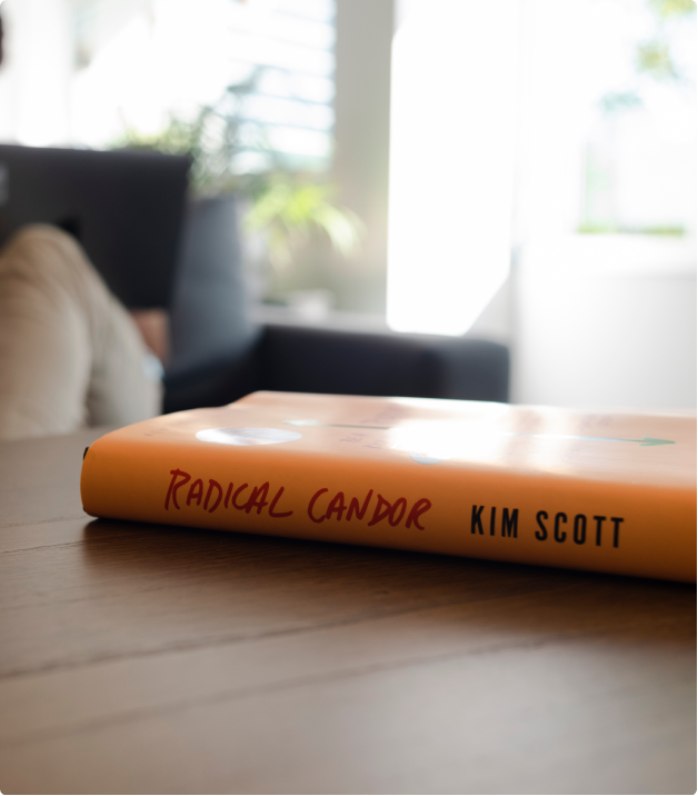 radical candor book on the table and a dev working behind it